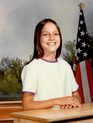jen-at-12-school-photo-with-flag-cropped